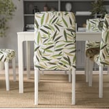 Chairs with removable, washable, leaf-patterned covers for easy cleaning and replacement, sitting on a woven rug.