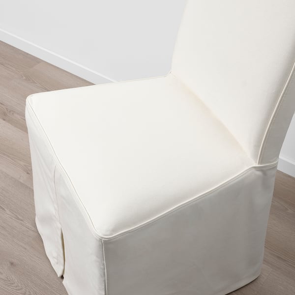 Modern, white upholstered chair with clean lines, showcasing high-quality fabric and detailed craftsmanship.