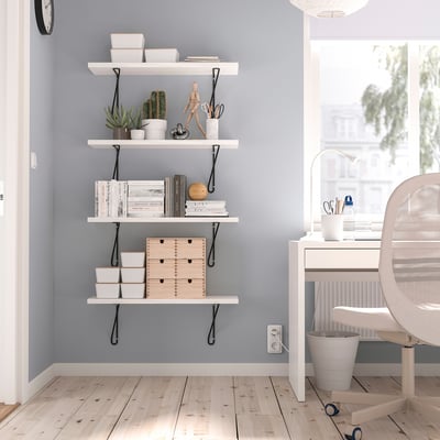 Modern home office with BERGSHULT shelf. Holds books, plants, decor. White desk & chair, office essentials by window.