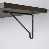 Dark wooden shelf supported by sleek, angled black metal brackets, securely mounted on a plain white wall.