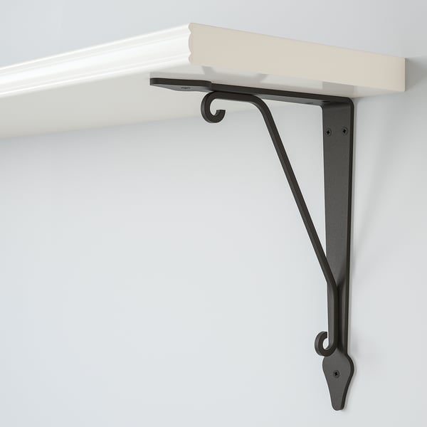 It shows a modern wall shelf mounted with sturdy metal brackets, featuring sleek design and high-quality finish.