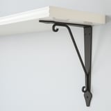 It shows a modern wall shelf mounted with sturdy metal brackets, featuring sleek design and high-quality finish.