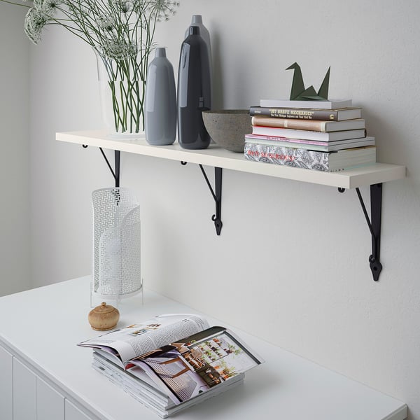 Modern BERGSHULT shelf with books, vases, and decor, securely mounted.