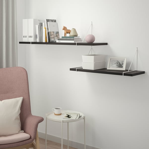 BERGSHULT shelves with decor. Armchair, cup, magazine.