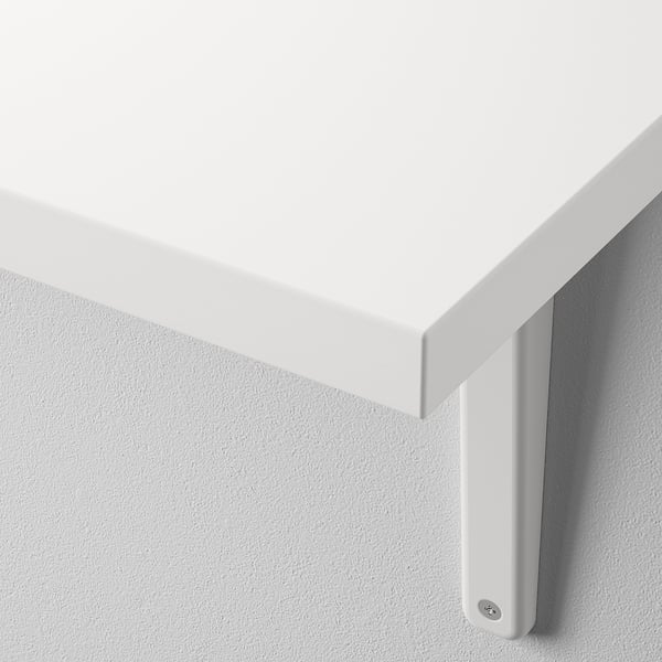 Close-up of modern white wall shelf with smooth edge, mounted securely against a wall.