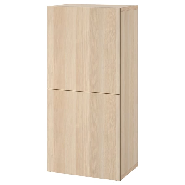 A light-colored wooden cabinet, part of the BESTÅ series, featuring two closed doors and a sleek rectangular design.