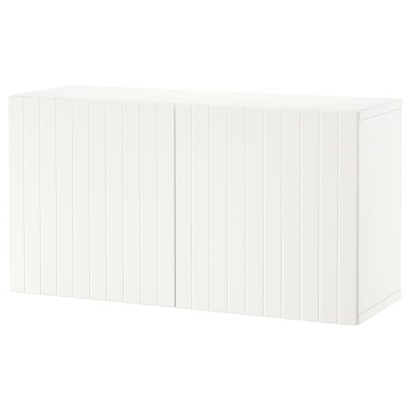 A white BESTÅ storage drawer unit. It is simple, rectangular, and wooden with a grooved design. Perfect for organizing home items.