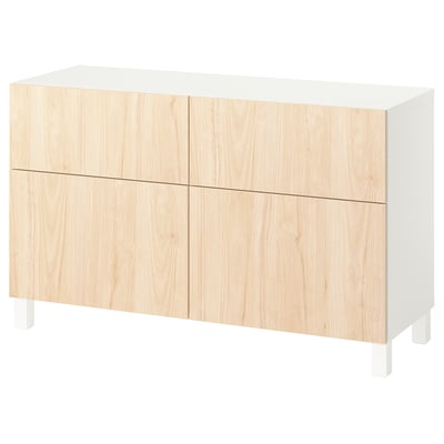 White BESTÅ sideboard with light wood doors, rectangular shape, minimalist design. Four doors, two shelves inside.