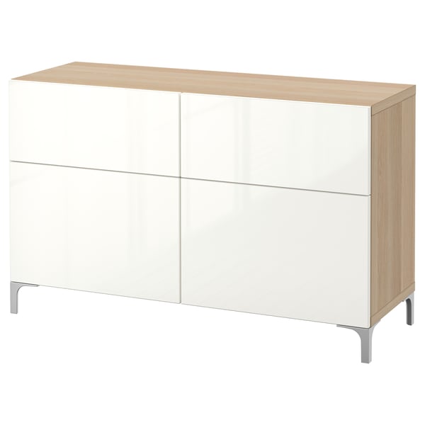 An ikea BESTÅ sideboard in white with wooden top and sides. It has four doors, two drawers, and stands on aluminum legs.