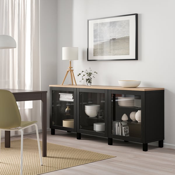 Modern room with BESTÅ sideboard, plates, lamp, plant, photo frame, curtains.