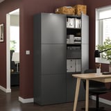 Gray BESTÅ storage with books, desk & chair, red walls.