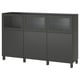 Black BESTÅ sideboard with glass doors and black legs, holding items privately.