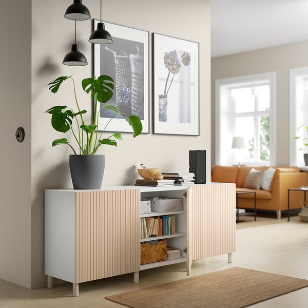 Modern living space with BESTÅ storage unit, books, plant, and decorations.