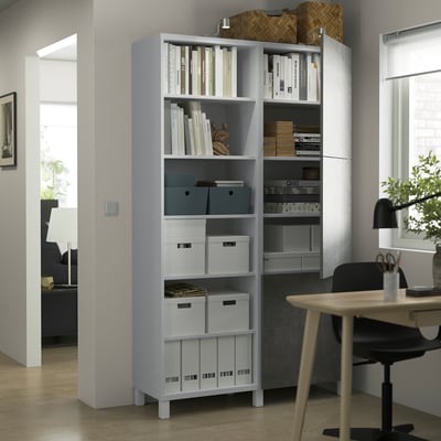 Modern BESTÅ storage with adjustable shelves, holding books, boxes, and decor.
