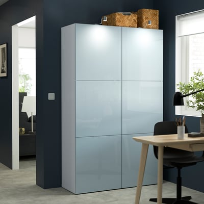 Modern home office: tall light blue BESTÅ storage, glossy, adjustable shelves, next to desk & chair.