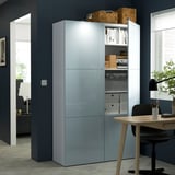 Modern storage unit with glass doors showcasing organized items. Includes shelves for books and boxes. The unit is integrated with office furniture.
