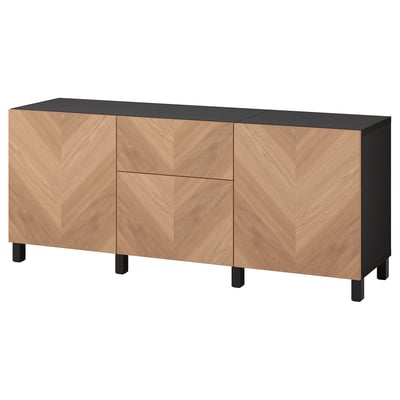Modern wooden cabinet, light wood, black top, three doors, rectangular shape, herringbone pattern.