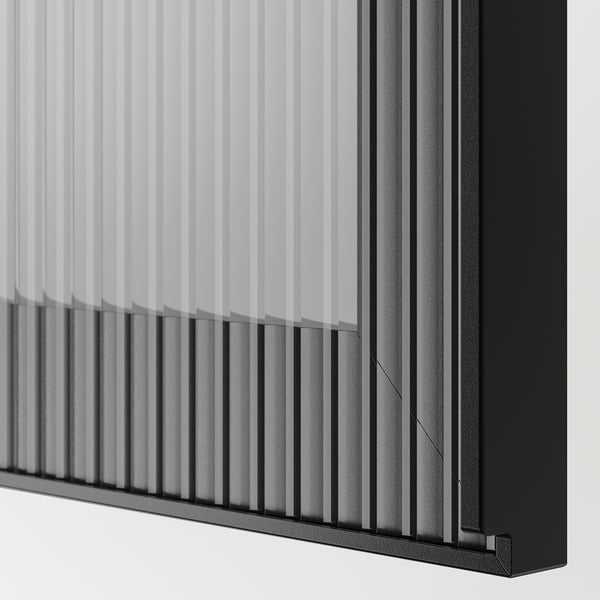Close-up of modern black and white BESTÅ shelving, showcasing sleek design and high-quality materials.