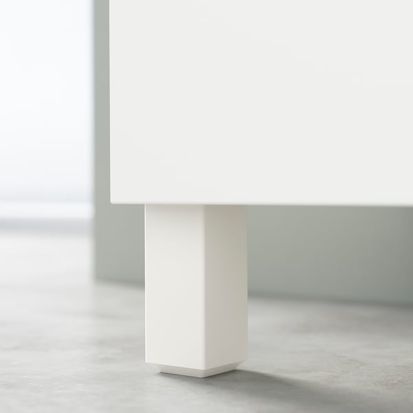 White BESTÅ cabinet leg detail. Square, sleek design with clean lines.