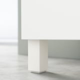 White BESTÅ cabinet leg detail. Square, sleek design with clean lines.