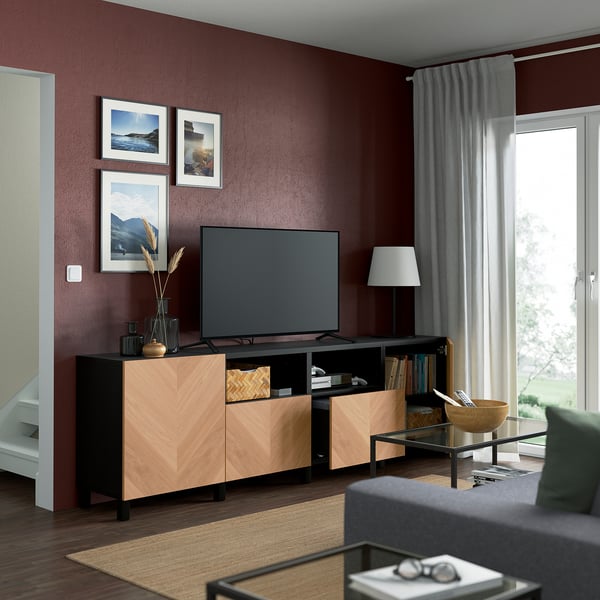 Maroon living room with BESTÅ tv bench, flat-screen tv, and decor.
