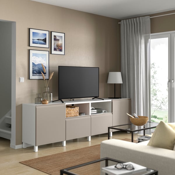 Modern living room with BESTÅ tv bench, flat screen tv, photos, decor, grey curtains, sofa, coffee table.