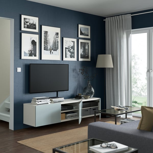 Modern living room with BESTÅ tv bench, flat-screen tv, and glass coffee table.