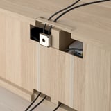 Cable management system integrated into wooden tv bench.