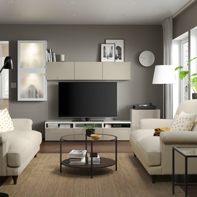 Modern living room with large tv & white sofas.