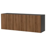 A wall-mounted BESTÅ cabinet in walnut finish. It four doors and offers airy, floor-freeing storage.
