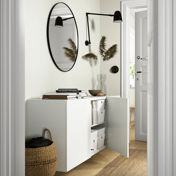 Modern hall with BESTÅ storage, mirror, lamps, wicker basket.