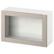 An ikea BESTÅ beige storage unit with a glass door. The rectangular design includes a simple, sleek frame and a glass panel for a modern look.