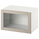 An ikea BESTÅ white storage unit with a single glass door. It has a rectangular shape and minimalist design.