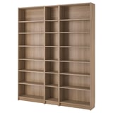 An empty BILLY bookcase. It is light brown, wooden, and rectangular with six open shelves. The design is simple and functional.