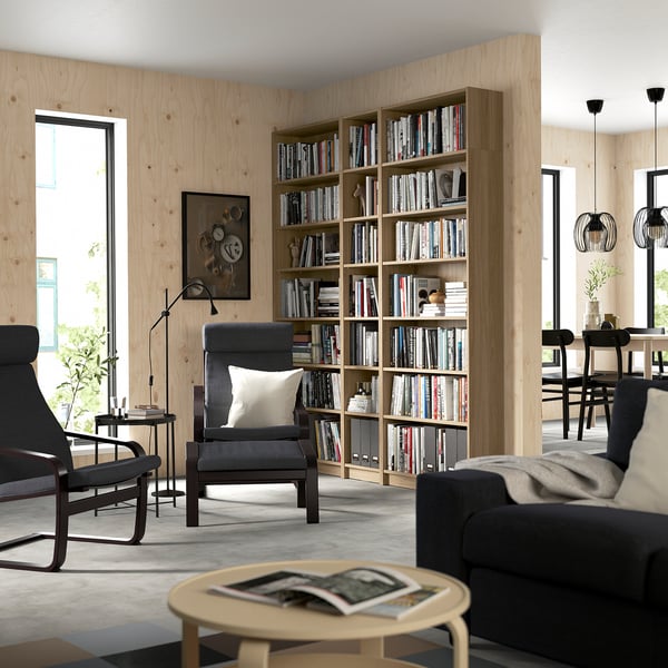 Modern living room with BILLY bookcase and dark grey seating area.