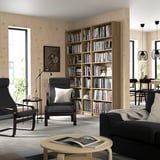 Modern living room with BILLY bookcase and dark grey seating area.