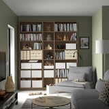 Cozy living room with BILLY bookcase, sofa, puzzle, & lamp.