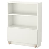A white BILLY bookshelf, a versatile storage unit with an adjustable shelf and a drawer on wheels.