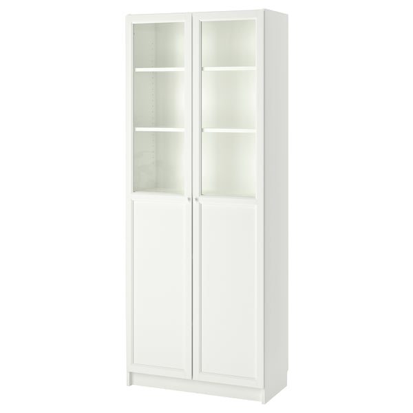 A BILLY bookcase in white, featuring glass doors and adjustable shelves, designed for versatile storage.