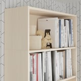 Light wood bookshelf with books, decorative items, and storage boxes. Anchored securely to the wall.