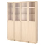 A BILLY bookshelf in white stained ash. It has four sections, with upper glass doors and lower solid doors. The shelves are adjustable.