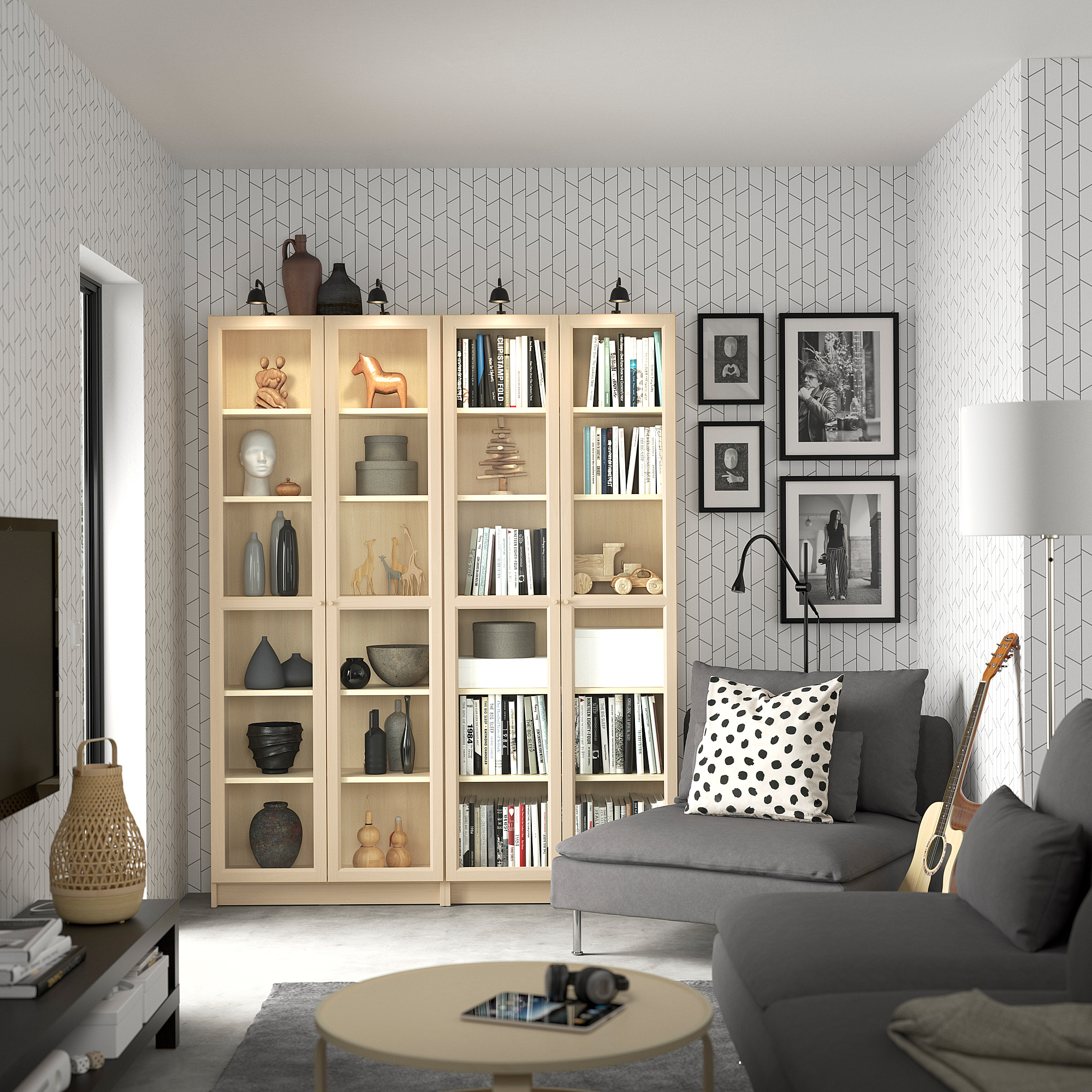 BILLY bookcase with glass doors and shelves in living room, decorated with items, books, frames, couch, and guitar.