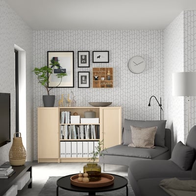 Modern living room with BILLY sideboard, sofa, books, decor, and plants.