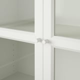White BILLY bookcase with glass doors and adjustable shelves.
