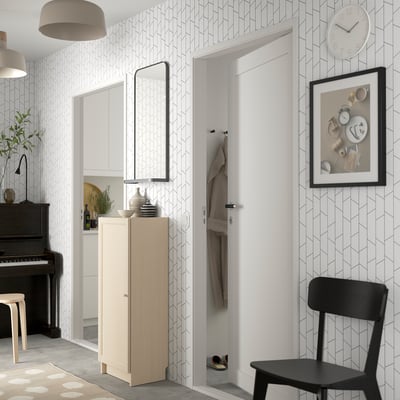 BILLY bookcase in stylish hallway, reflecting room in mirror, with chair.