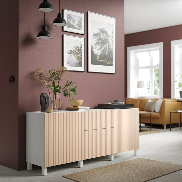 Modern living room with BJÖRKÖVIKEN sideboard in pale birch. Decorated with plants and framed art. Yellow sofa and large window.