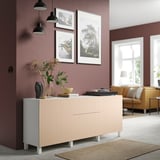 Modern living room with BJÖRKÖVIKEN sideboard in pale birch. Decorated with plants and framed art. Yellow sofa and large window.