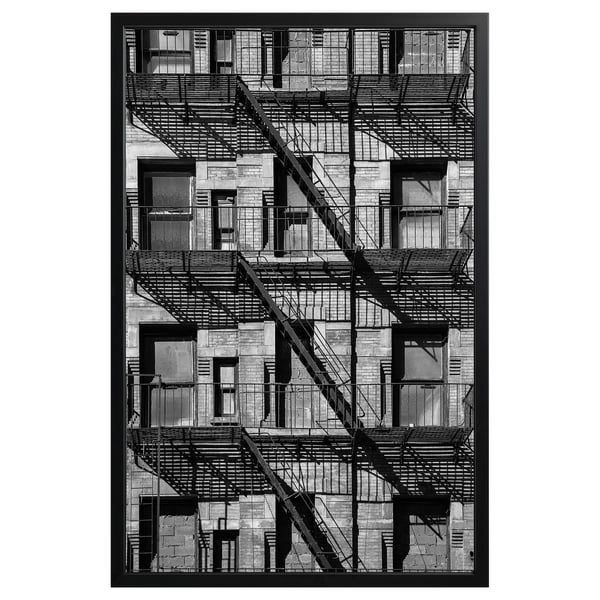 Black and white framed photograph of nyc fire escapes on brick building.