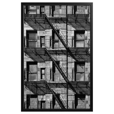 Black and white framed photograph of nyc fire escapes on brick building.