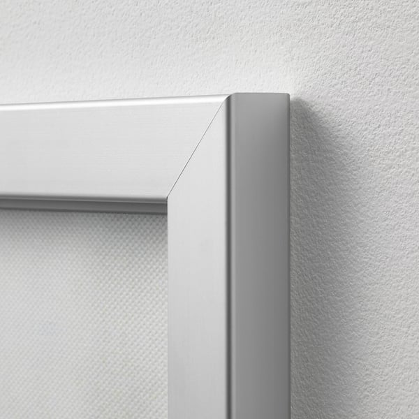 Close-up of a modern, metallic picture frame corner, showcasing its sleek and high-quality design.